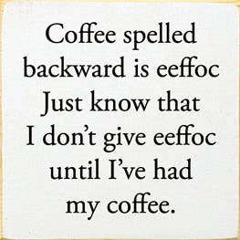 Wood coffee sign with black quote text: 'Coffee spelled backward is eeffoc...'