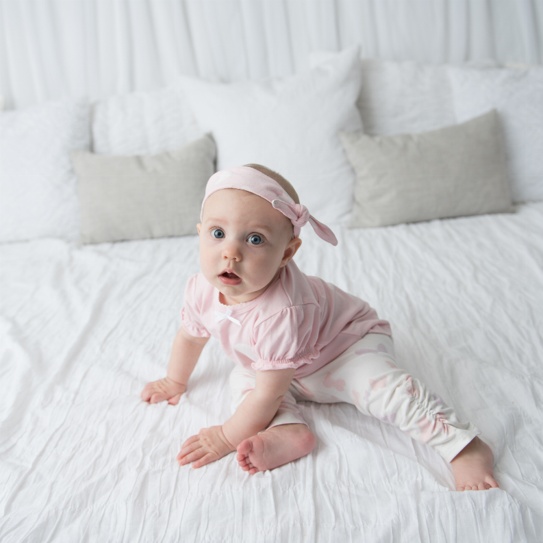 Light pink baby girl short-sleeve T-shirt with front ruffle detail and cuffed sleeves