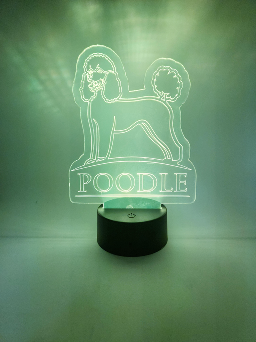 Black cylinder poodle LED lamp casting green 'POODLE' outline light