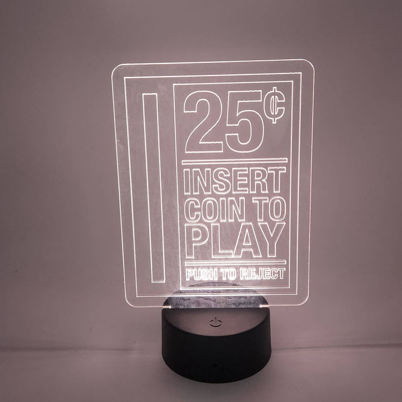 Arcade LED lamp with “25¢ Insert Coin to Play” sign and round black base