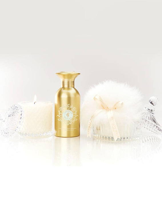 Crystal gift set with gold glass bottle and three white decorative candles