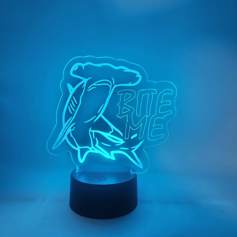 Shark LED novelty lamp with neon blue outline and “BITE ME” on round base