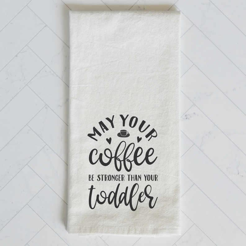 Cream kitchen towel with 'May your coffee be stronger than your toddler' typography