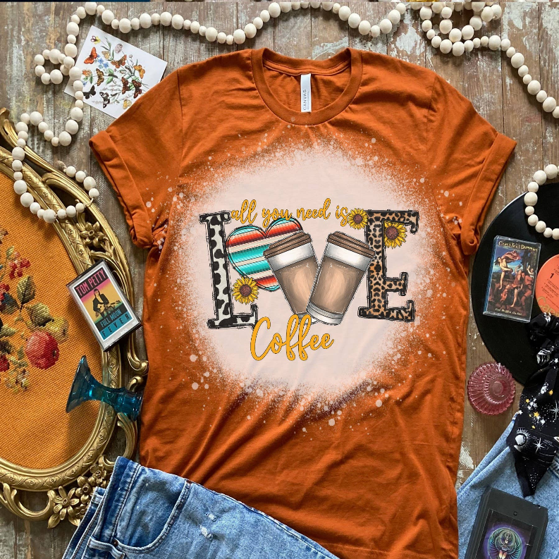 Rust orange crew-neck T-shirt with 'Coffee' mugs print in decorative frame.