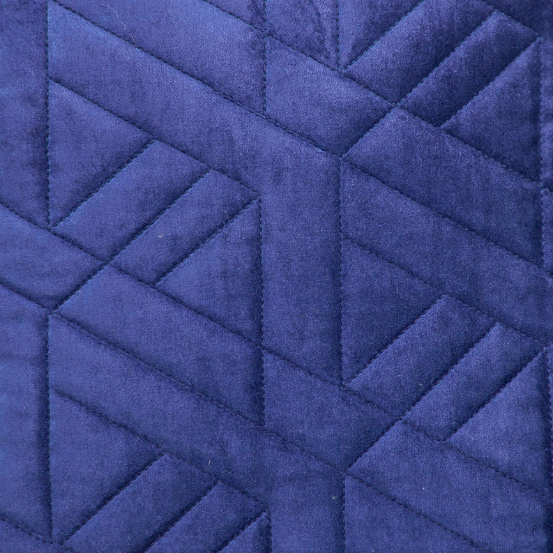 Blue quilted throw pillow fabric detail with raised diamond-stitched quilting