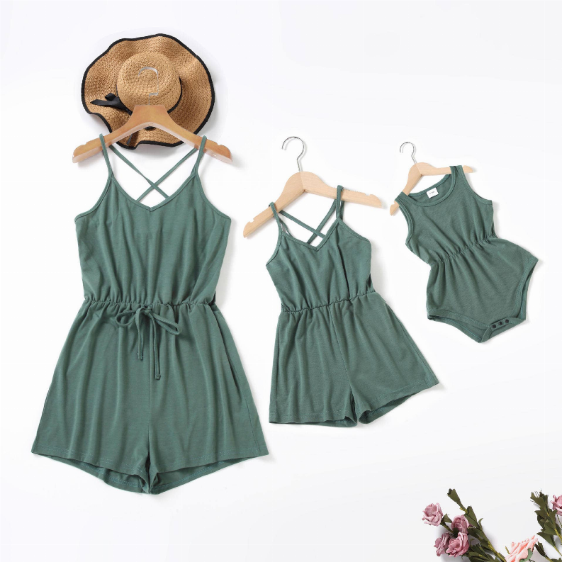 Three matching green sleeveless rompers: mom, mini, and small, with crisscross back straps
