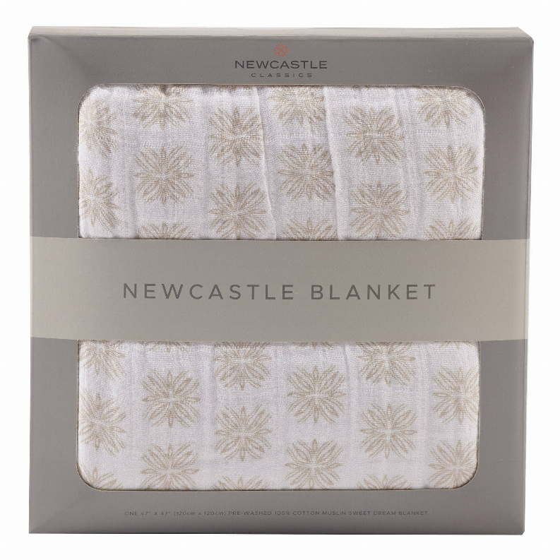 Folded cream blanket with gold leaf pattern and stitched edge, shown in gift packaging