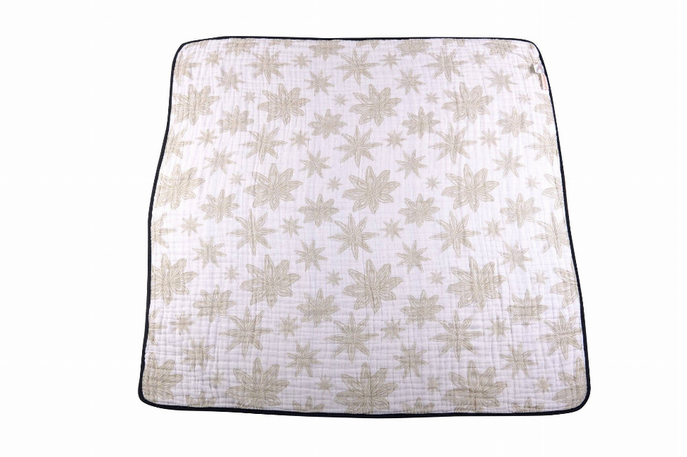 Cotton muslin blanket with light beige allover leaf star pattern