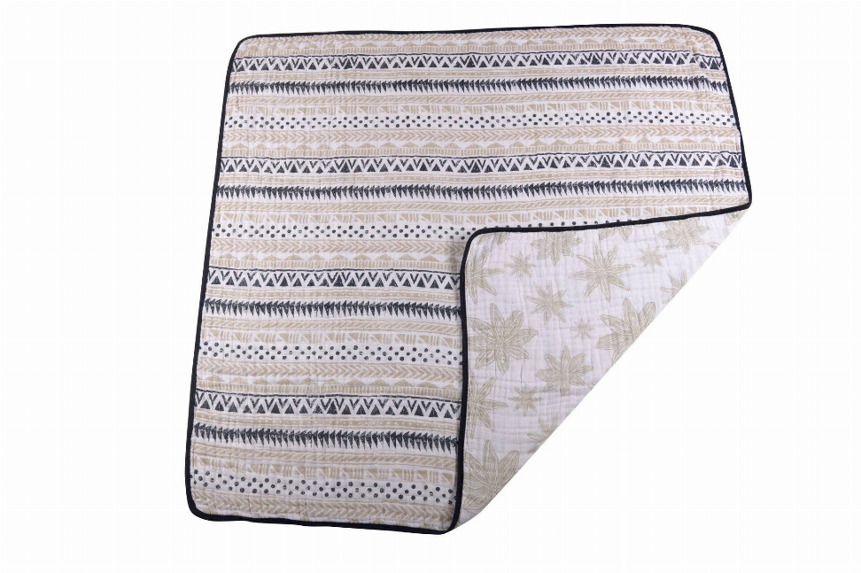 Cotton muslin blanket with striped front and botanical leaf print reverse
