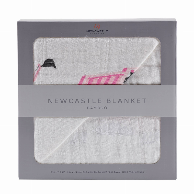 White bamboo blanket with pink vehicle and digger pattern, neatly folded