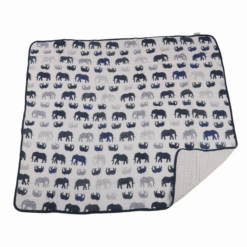 Folded blanket with repeating navy animal silhouettes on light background
