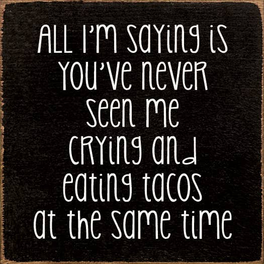 Black square sign with white handwritten-style quote text