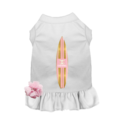 White sleeveless dog dress with pink surfboard graphic and ruffled skirt hem.