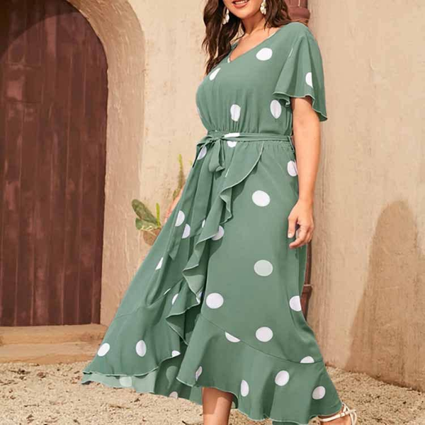 Plus-size green polka-dot midi dress with ruffle skirt, flutter sleeves, waist tie
