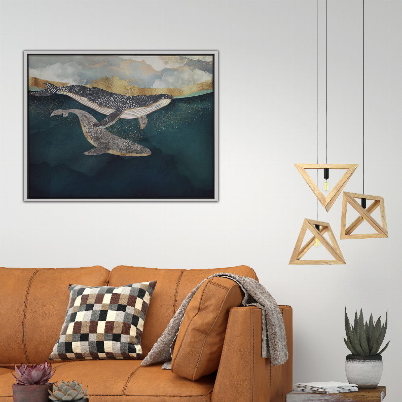 Framed ocean art print with three whales, teal water, and cloudy sky