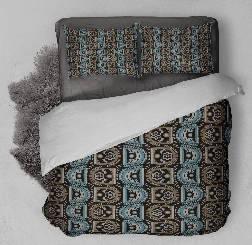 Comforter set with geometric blue and black pattern on dark bedding and matching pillows