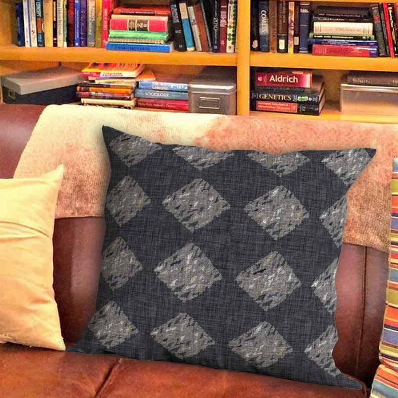 Dark gray throw pillow with repeating light gray diamond motif