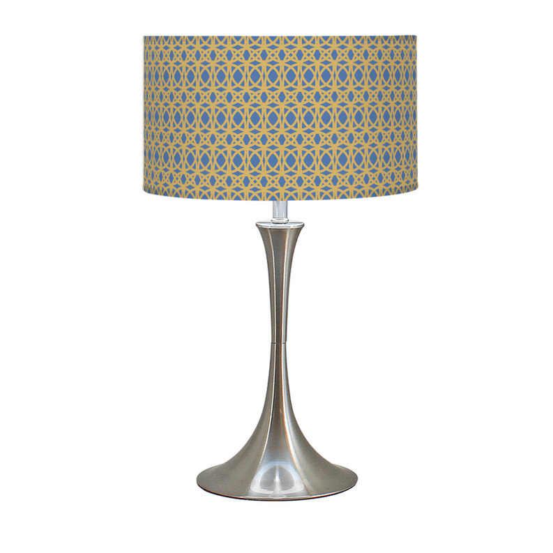 Table lamp with blue-and-gold patterned drum shade and brushed metal hourglass base