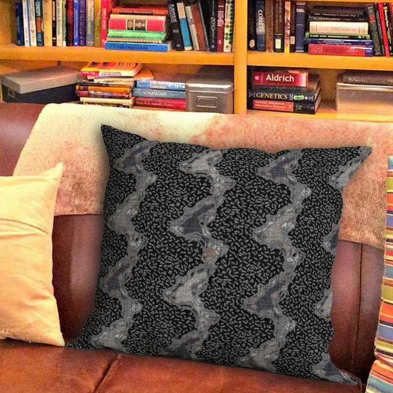 Decorative pillow with black and gray speckled abstract pattern