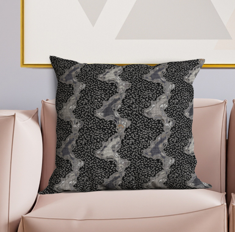 Decorative throw pillow with black and gray abstract pattern