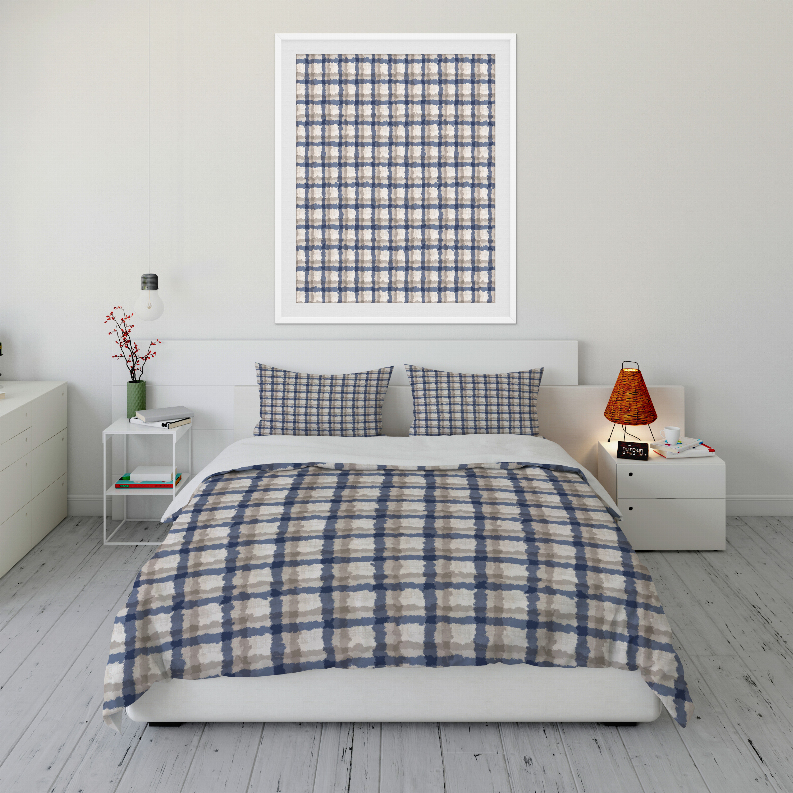 Blue plaid comforter set on bed with two matching square pillow shams