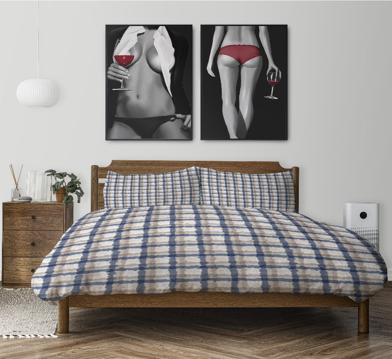 Blue plaid comforter over a bed with two matching pillow shams