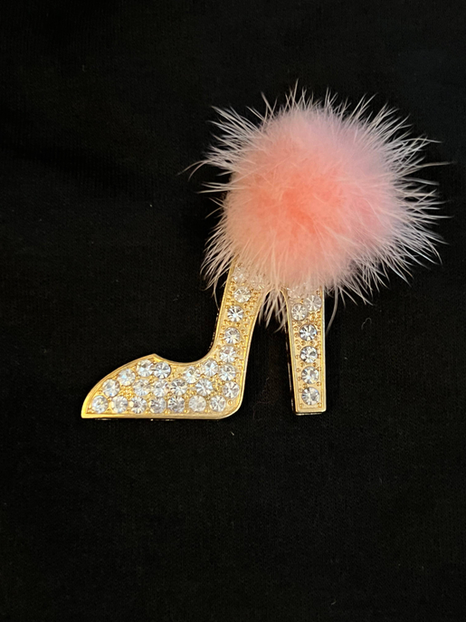 Gold glitter high-heel patch with pink fuzzy pom-pom on black fabric