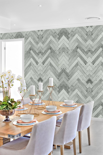 Peel-and-stick wallpaper panel with light gray herringbone chevron wood pattern