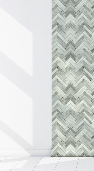 Peel-and-stick wallpaper panel corner seam, gray chevron wood pattern