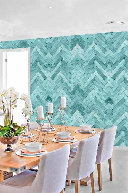 Peel-and-stick vinyl wallpaper panel on accent wall with teal chevron pattern