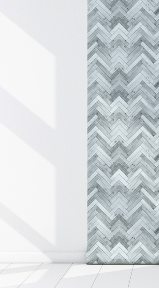 Corner view of peel-and-stick vinyl wallpaper panel with light blue-gray chevron pattern