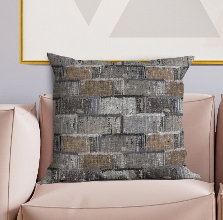 Square throw pillow with textured gray and tan patchwork