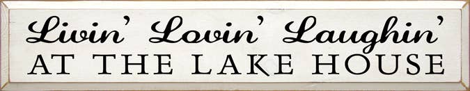 Lake house wood sign with cursive text “Livin’ Lovin’ Laughin’” and “AT THE LAKE HOUSE”