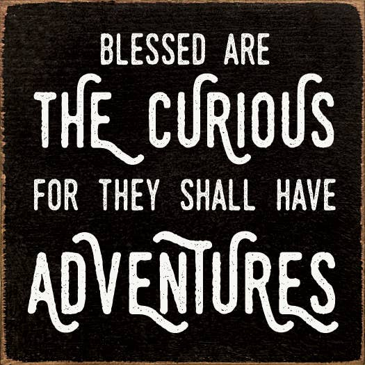 Black quote print with white distressed lettering: Blessed are the curious