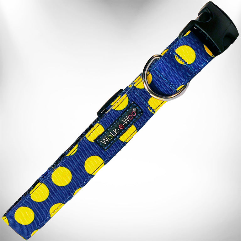 Dog collar with yellow polka dots on blue fabric, black buckle and metal D-ring