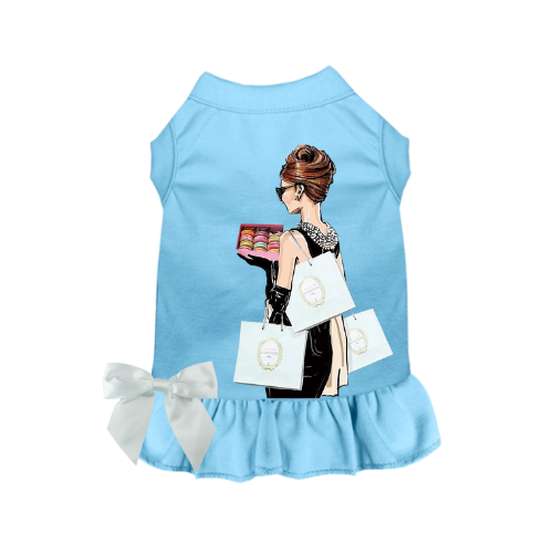 Light blue dog dress with ruffled hem, bow tie, and shopping-bags graphic