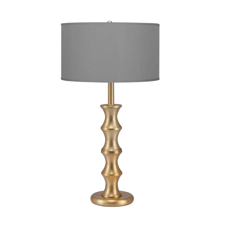 Brushed brass table lamp with gray fabric drum shade and bamboo-style stacked base
