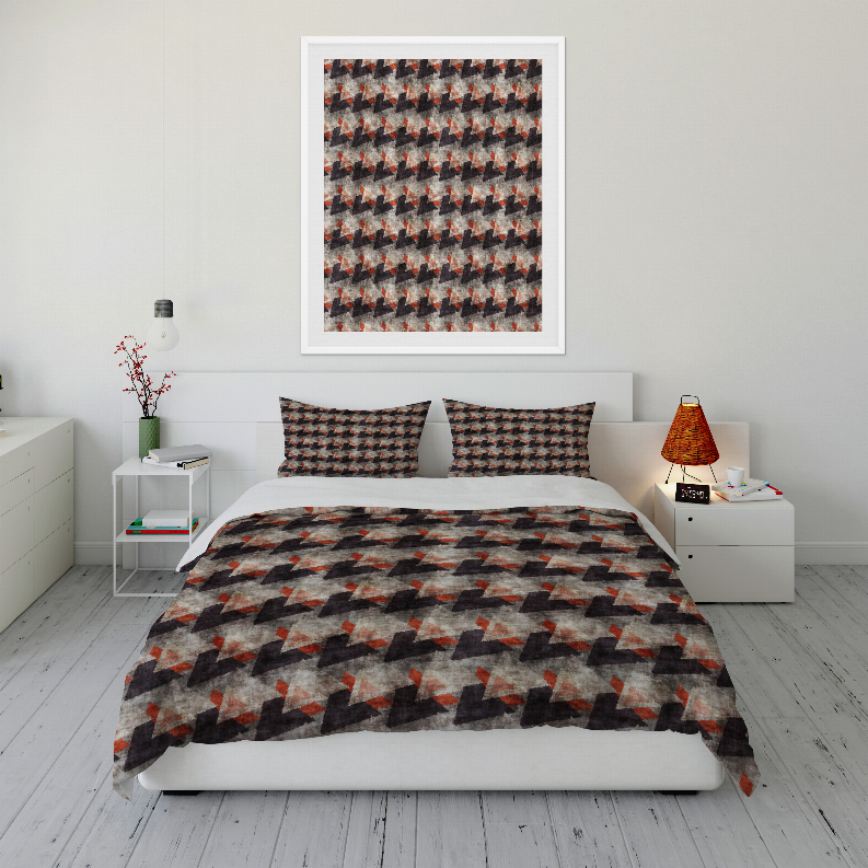Multi-color quilted comforter set with geometric pattern and two pillow shams on bed