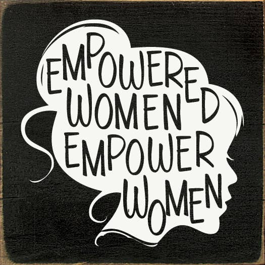 Dark wood sign with white quote text: EMPOWER WOMEN and EMPOWER MEN