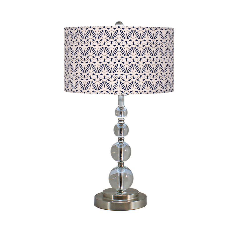 Table lamp with geometric-pattern drum shade and stacked clear glass globe base