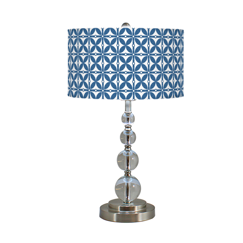 Table lamp with blue patterned fabric shade and chrome stacked sphere base