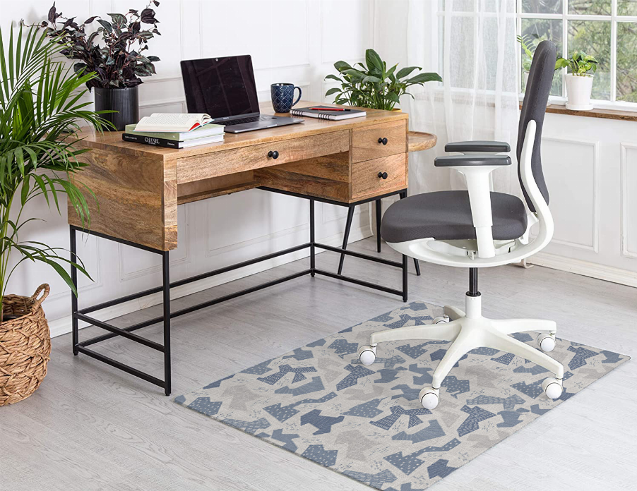 Low pile carpet rug with blue-and-gray geometric pattern under office chair