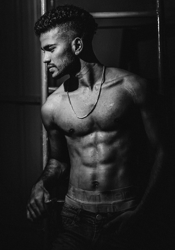 Black-and-white framed wall art featuring a muscular man torso portrait, close-up view