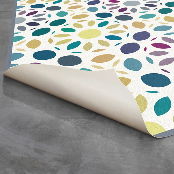 Multi-color mosaic vinyl rug with leaf-like shapes and curled edge detail