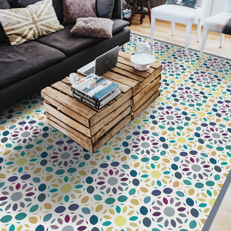 Multi-color mosaic vinyl rug with repeating leaf-dot pattern, laid on floor