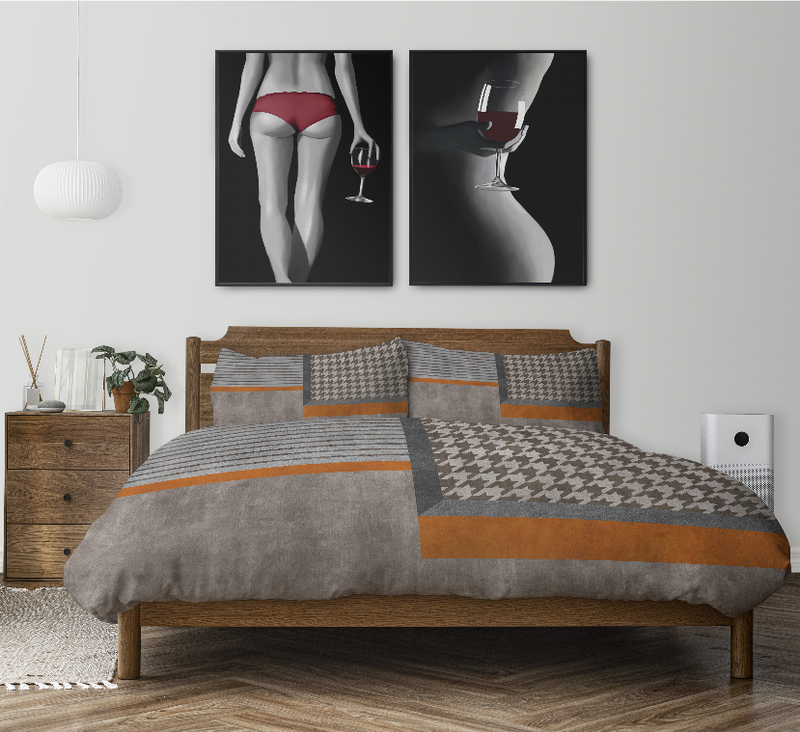 Gray comforter set on bed with houndstooth center panel and orange trim pillow shams