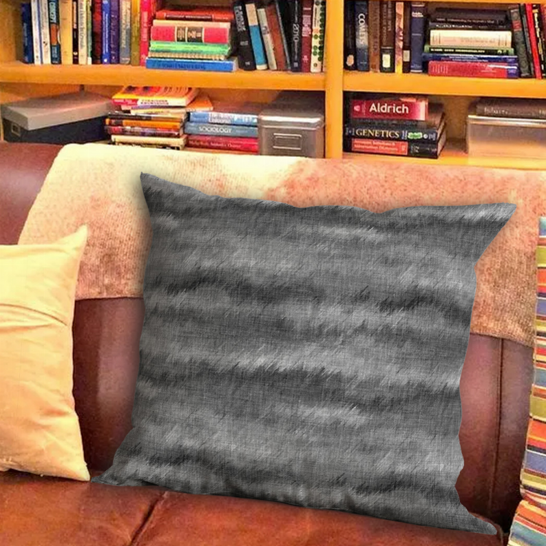 Square grey cushion with textured pattern and dark mottled lines