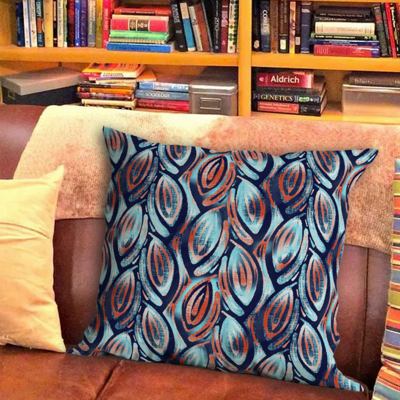 Decorative throw pillow with blue and rust leaf swirl pattern
