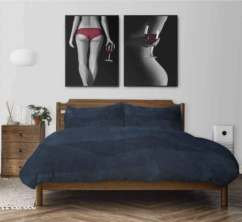 Dark blue comforter set on wooden bed with two pillow shams and quilted waves