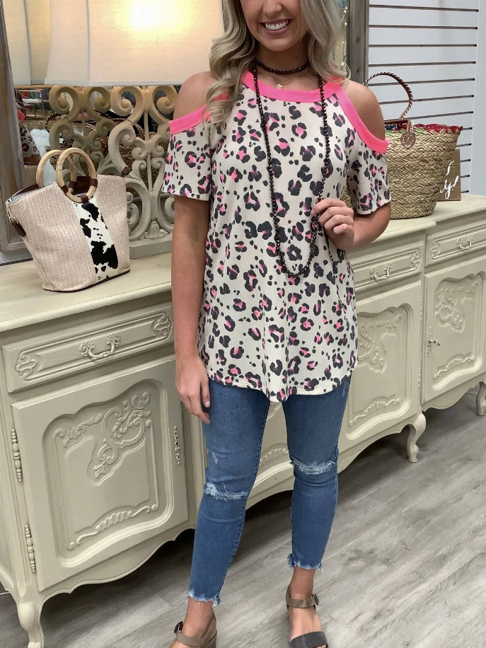 Women’s leopard print cold-shoulder tunic top with pink sleeves and ruffle neckline trim